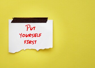 Stick note on yellow copy space background with handwriting text PUT YOURSELF FIRST -  Prioritize...