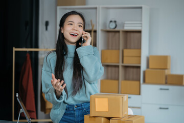 Portrait young attractive asian female owner startup business work happy with box at home prepare...