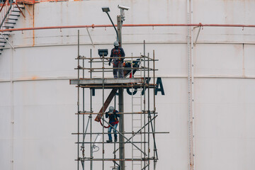 Construction workers installing scaffolding storage tank Oil​ refinery​ and​ plant and tower column of Petrochemistry industry