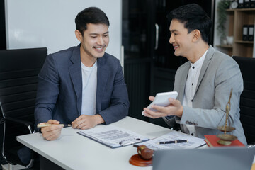 Lawyer or accounting department writes a note and uses a calculator to calculate expenses - income. at office lawyer.