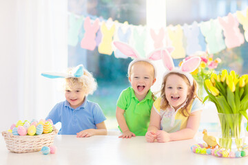 Fototapeta premium Kids on Easter egg hunt. Children dye eggs.