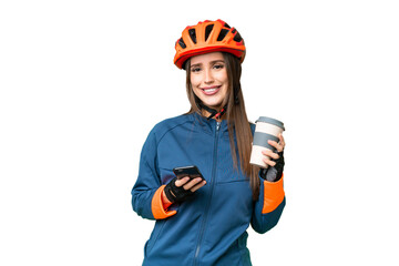 Young cyclist woman over isolated chroma key background holding coffee to take away and a mobile