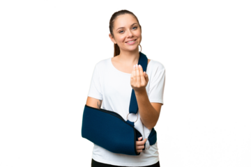 Young blonde woman with broken arm and wearing a sling over isolated chroma key background inviting to come with hand. Happy that you came