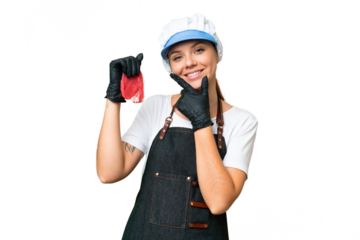 Butcher woman wearing an apron and serving fresh cut meat over isolated chroma key background happy and smiling