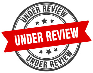 under review stamp. under review label on transparent background. round sign