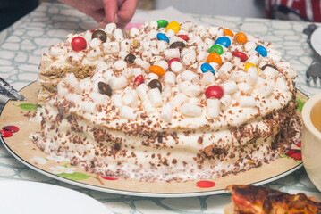 Fototapeta na wymiar festive children's birthday cake is being cut