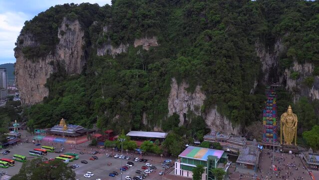 Hindu giant cave Batu golden Buddha statue Perfect aerial top view flight drone 