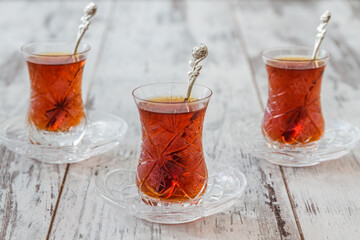 Traditional Turkish Tea Served in Authentic Glasses on a White Wooden Table