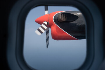 Blue sky seen through the window of a flying seaplane.