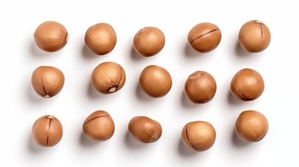 Macadamia nuts are isolated against a white background, captured from a top-down view.