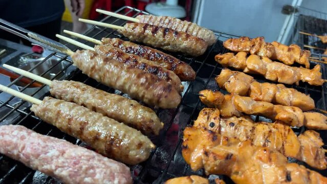 flipping pork barbecue a famous Filipino street food . High quality 4k footage