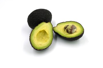 Avocado cut in half on white background