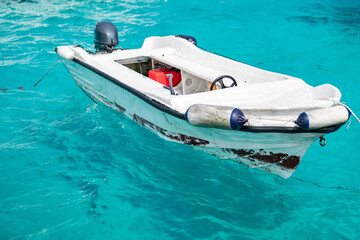 Old speed boat in azure transparent water sea.