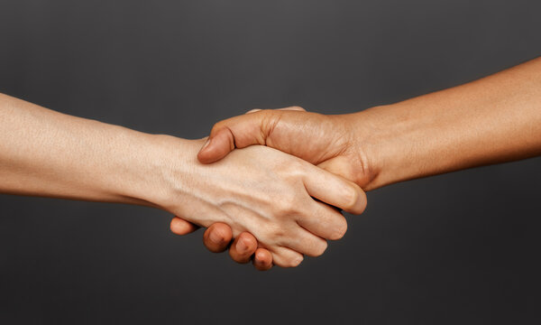 Close Up of Two People Shaking Hand together. Sign of Human Cooperation ,Agreement, Congratulations, Mergers and Acquisitions. Greeting or Finishing up Meeting. Handshaking with Great Deal.