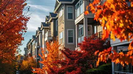 Tuinposter Vibrant Autumn Foliage Surrounding Apartment Building Creates Stunning Landscape © AIGen