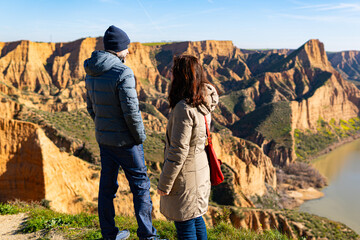 estranged angry couple think about their divorce in breathtaking scenery of mountains and red cliffs