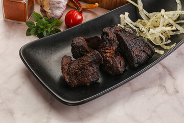 Grilled beef barbecue served onion