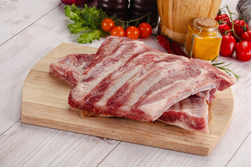 Raw pork ribs over board