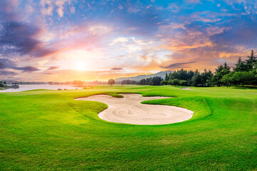 Green golf course nature landscape at sunset