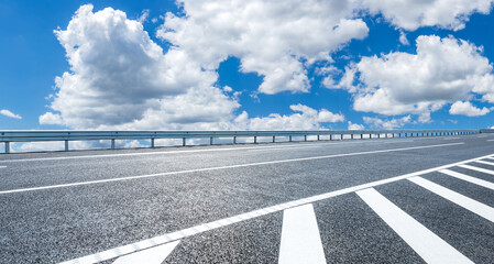Asphalt highway and sky clouds background