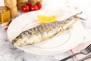 Grilled sea bass fish served lemon