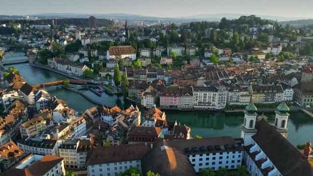 Aerial morning view of Lucerne old town and Reuss river. View of Jesuitenkirche Hl. Franz Xaver church and old houses in Luzern city center, Switzerland, shot at sunrise
