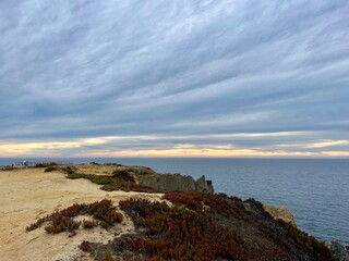 Fantastic rocky coast, cloudy sky, twilights time, ocean horizon