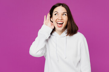 Young curious nosy happy Caucasian woman she wear light hoody casual clothes try to hear you...
