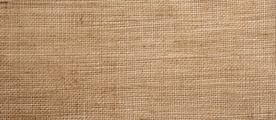 Fototapeta na wymiar This close-up view showcases the intricate details of a brown fabric texture. The texture features a subtle weave pattern, adding depth and richness to the visual. The warm brown hue contributes to a