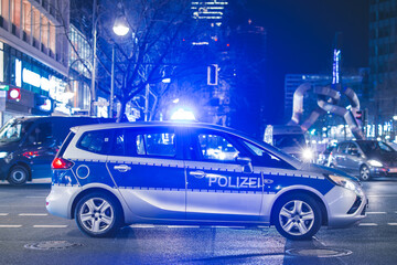 German police car waiting on the road and arranging traffic. Police car blocking the traffic in germany as a safety measure at an event.