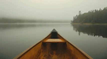 Poster Bow of a canoe in the morning on a misty lake in Ontario, Canada.  © Emil