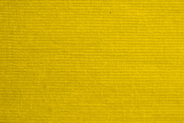 yellow corduroy fabric texture used as background. clean fabric background of soft and smooth textile material. cloth, velvet, .luxury lemon tone for silk.