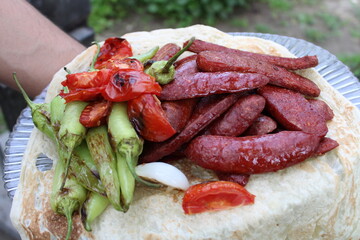Baked sausage tomatoes and peppers on white bread
