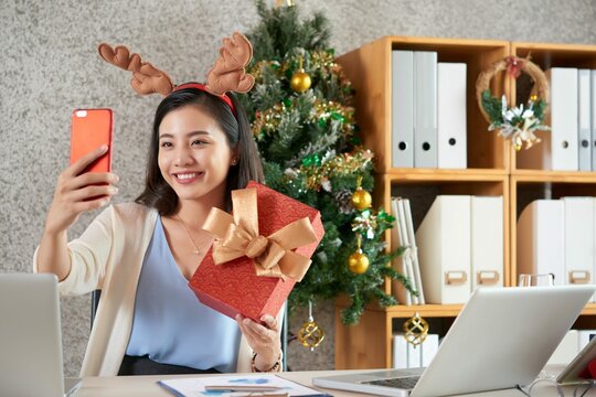 Happy Young Asian Woman Reindeer Hairband Taking Selfie With Christmas Present