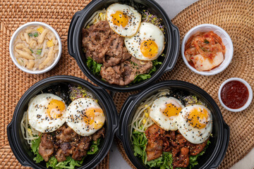 Korean food, bulgogi, bibimbap, beef, vegetables, eggs, side dishes, kimchi, fried tofu, red pepper paste