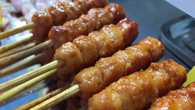 Pork meat skewer on fire, Mutton barbecue close-up. Fried meat for kebab. Cooking grilled meat beef chicken lamb BBQ . Kebab on grill. Chinese street local market with traditional food. 