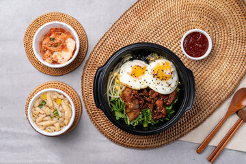 Korean food, bulgogi, bibimbap, beef, vegetables, eggs, side dishes, kimchi, fried tofu, red pepper paste