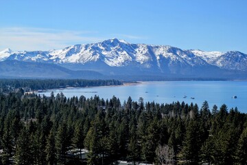 view of lake tahoe in front of the snowy mountain