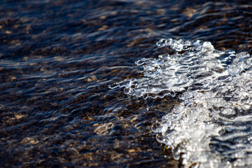 Frozen water close-up, streams of water flowing in streams.