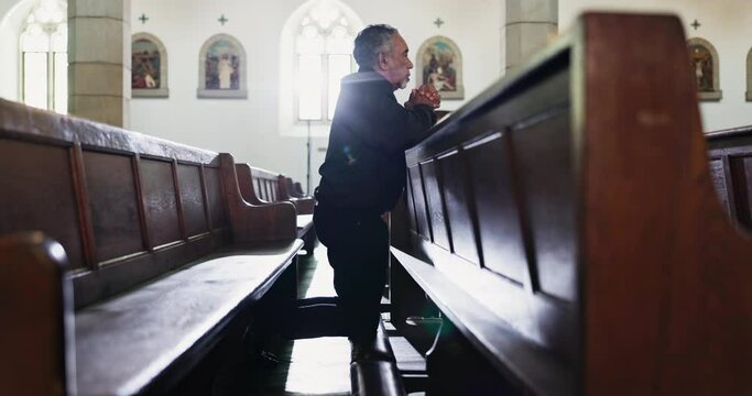Sad, man and praying in church with faith at funeral, service and memorial ceremony in religion for death. Mourning, person and thinking of memory or respect prayer with worship in Christian chapel
