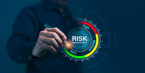 A man is pointing at a risk management level on a screen