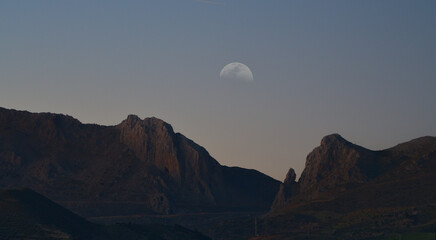 Mountains with the crescent in a double exposure photograph