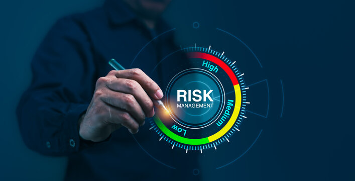 A man is pointing at a risk management level on a screen - Powered by Adobe