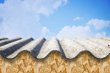 Old aged dangerous roof made of prefabricated corrugated panels with wooden structure