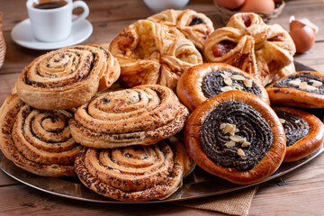 Bakery - various homemade pastries on table. Bread rolls, buns, sweet bun. Homemade bakery concept for background and wallpaper.