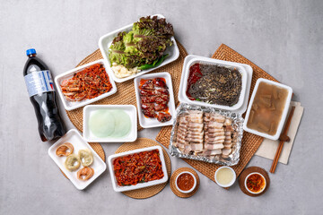 Korean food, pork feet, boiled pork, bossam, garlic, red pepper, lettuce, ssamjang, makguksu, dumpling