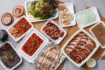Korean food, pork feet, boiled pork, bossam, garlic, red pepper, lettuce, ssamjang, makguksu, dumpling