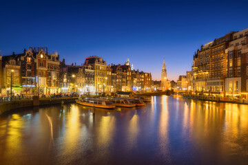 Amsterdam, Netherlands. Evening cityscape. Dark sky and city lights. Dutch canals. Reflections on...