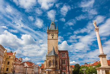 Old Town Hall medieval clock tower among clouds in Prague, a city landmark erected in 1364 in Old Town Square, with Marian Column - 754862209