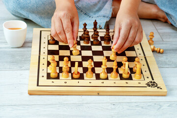 female hands placing pieces on a chessboard